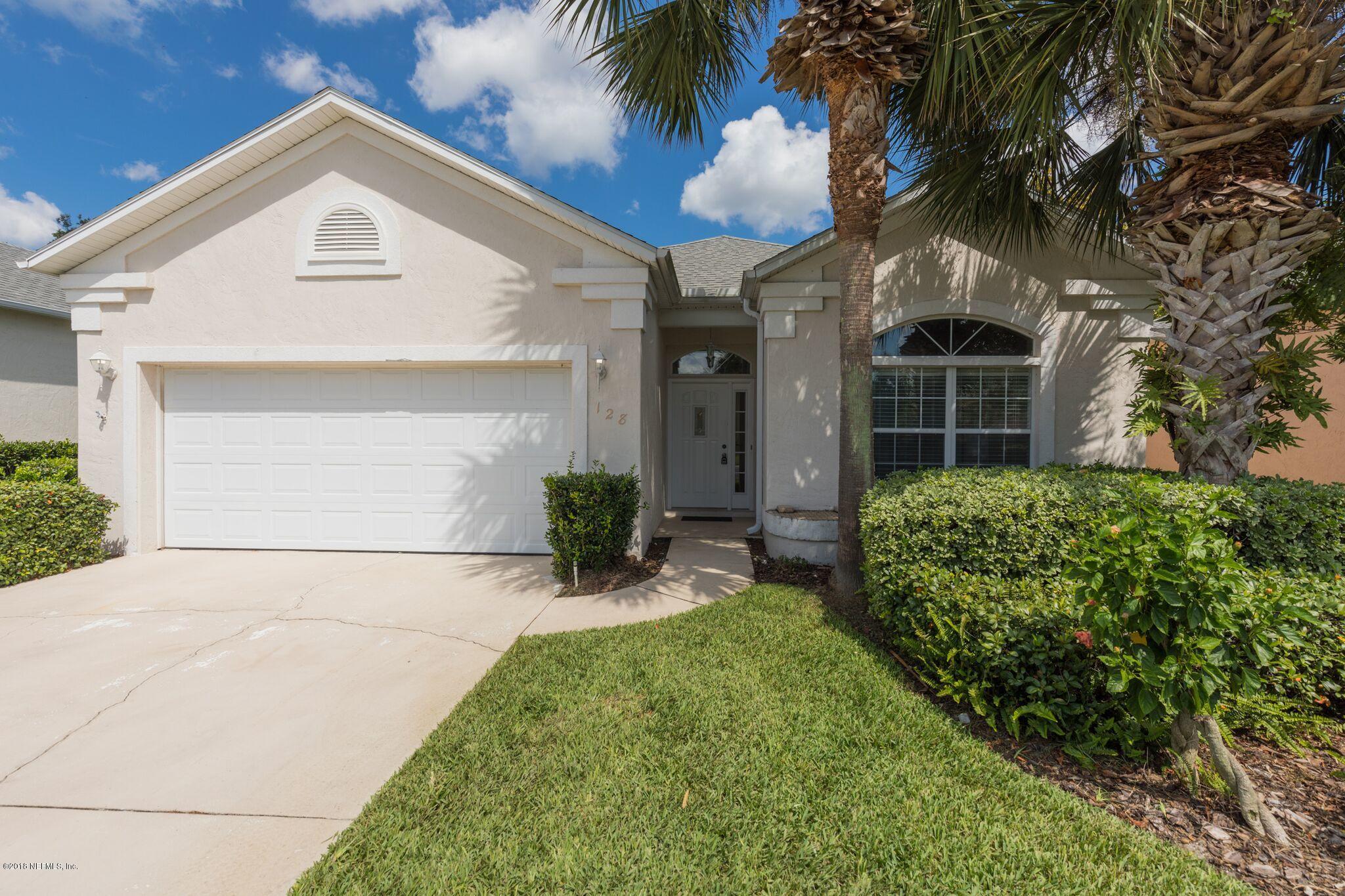 128 Cedar Ridge Circle St. Augustine, FL 32080 - Photo 2 of 37 a front view of a house with a yard and potted plants