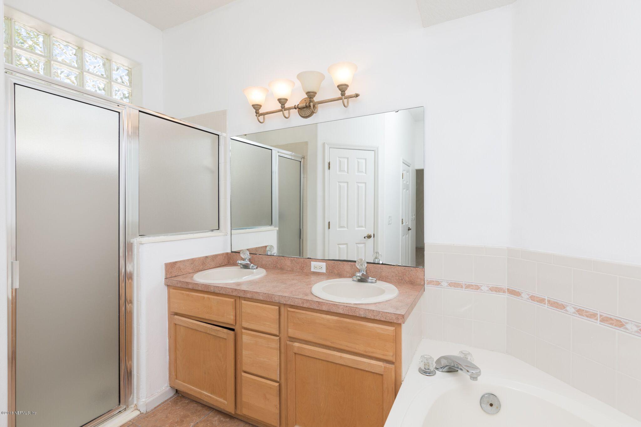 128 Cedar Ridge Circle St. Augustine, FL 32080 - Photo 27 of 37 a bathroom with a sink and a mirror
