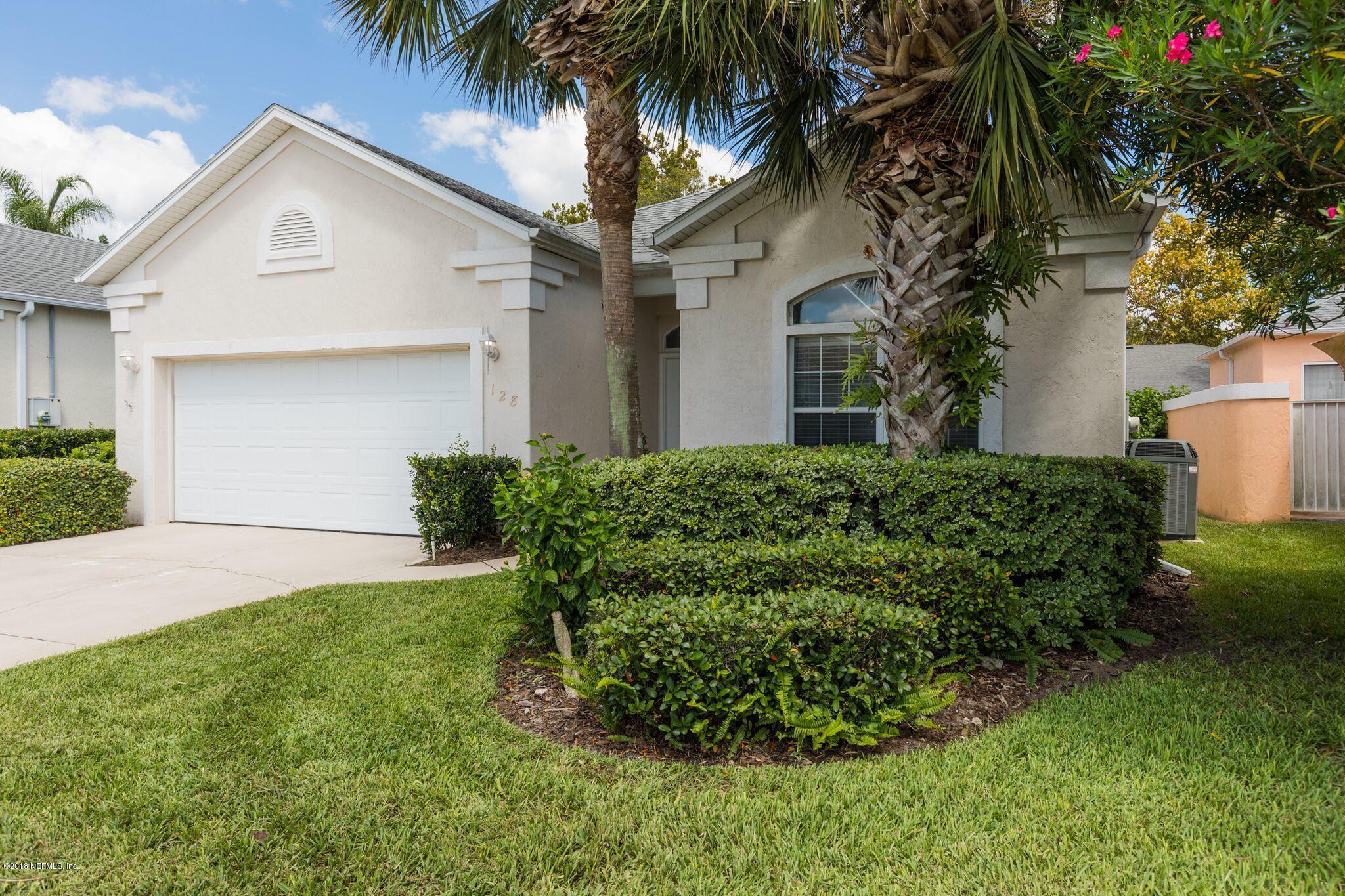 128 Cedar Ridge Circle St. Augustine, FL 32080 - Photo 3 of 37 a front view of a house with a garden