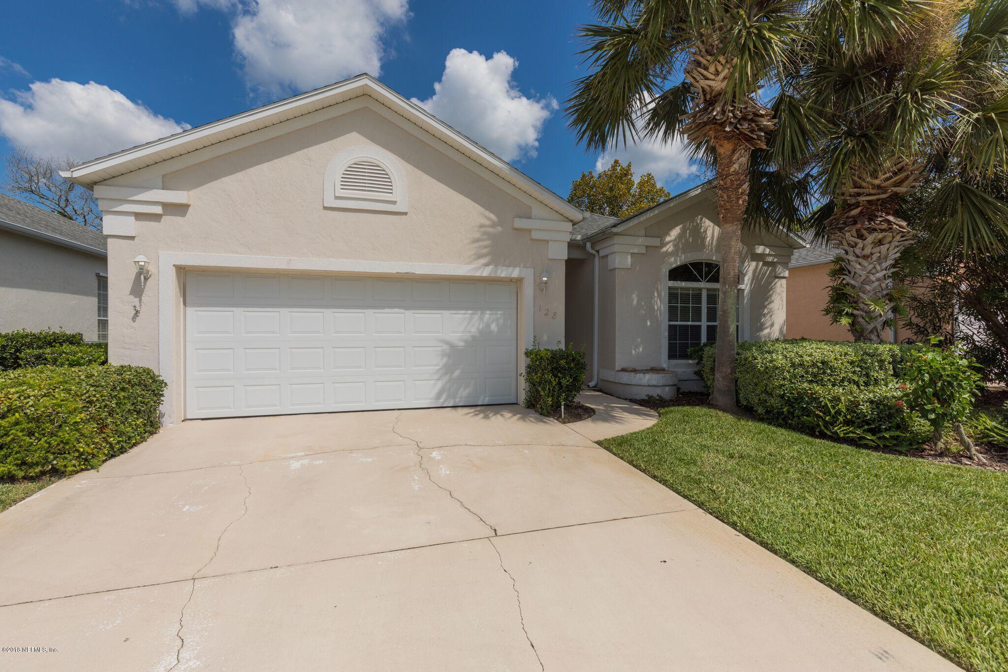 128 Cedar Ridge Circle St. Augustine, FL 32080 - Photo 4 of 37 a front view of a house with a yard and potted plants