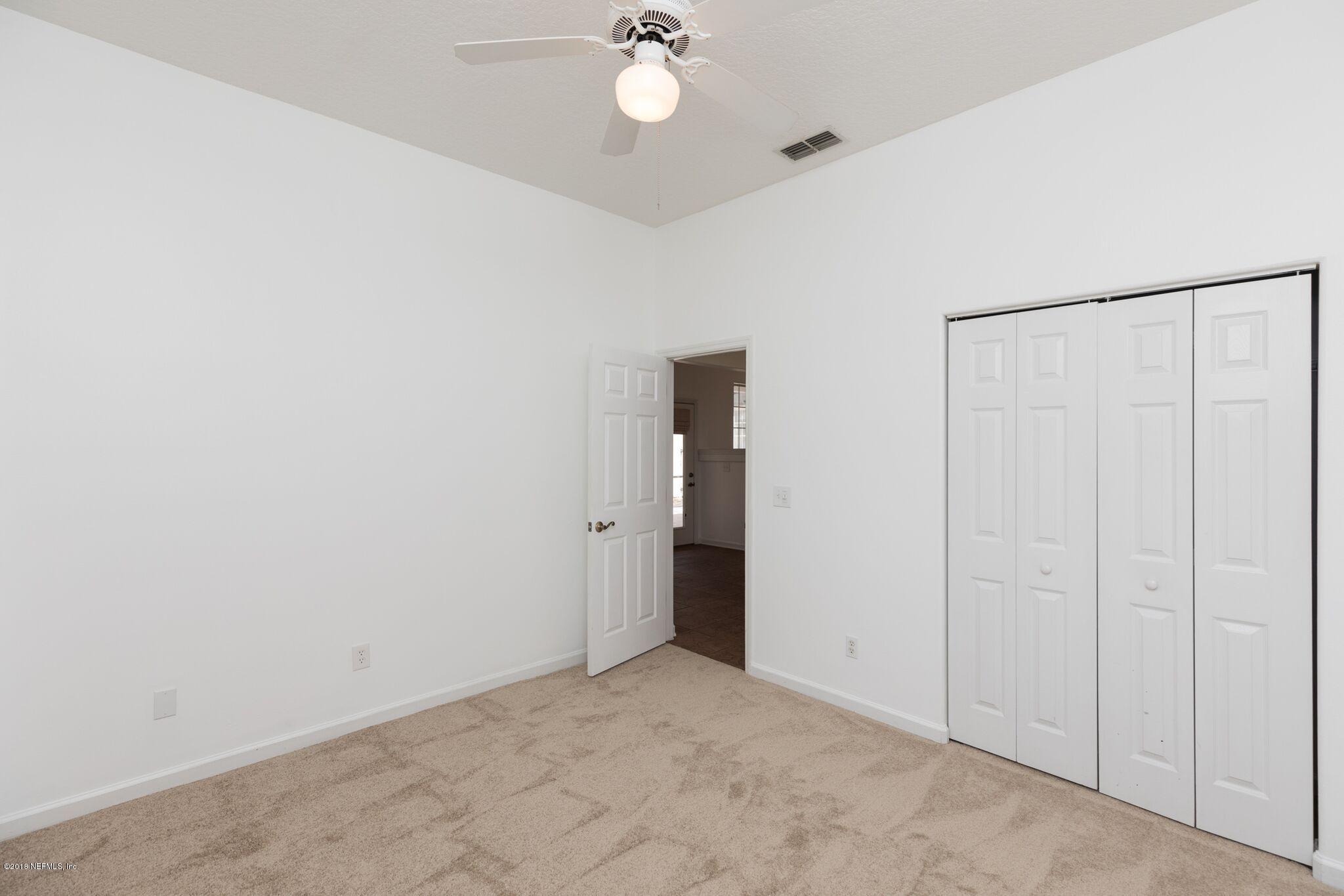 128 Cedar Ridge Circle St. Augustine, FL 32080 - Photo 9 of 37 a view of an empty room with a chandelier fan