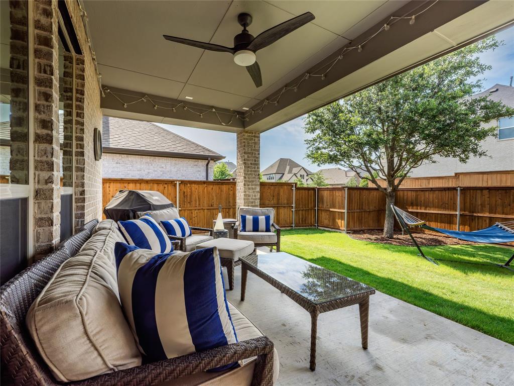 15340 Crape Myrtle Road Frisco, TX 75035 - Photo 38 of 40 Covered patio featuring a ceiling fan, string lighting, and direct access to a fenced yard with a mature tree