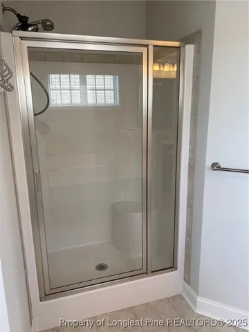 a bathroom with a glass shower door