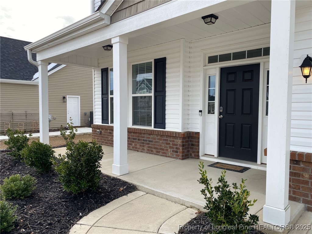 277 Pendleton Street Raeford, NC 28376 - Photo 27 of 29 front view of a house with a potted plant