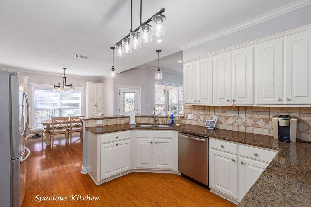 298 Spring Creek Drive Nacogdoches, TX 75965 - Photo 15 of 45 a kitchen with a sink a counter top space cabinets and stainless steel appliances