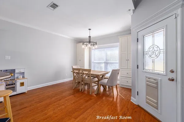 a view of a dining room with furniture and wooden floor