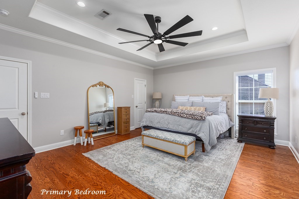 298 Spring Creek Drive Nacogdoches, TX 75965 - Photo 20 of 45 a spacious bedroom with a bed a dresser and a chandelier
