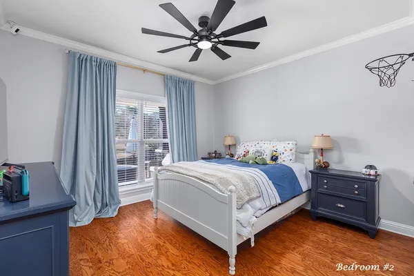 a spacious bedroom with a bed and a chandelier
