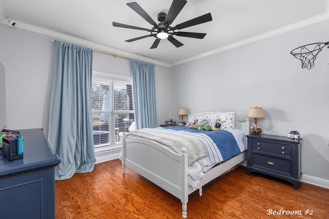 a spacious bedroom with a bed and a chandelier