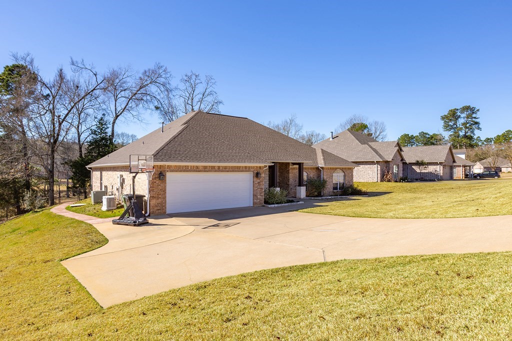 298 Spring Creek Drive Nacogdoches, TX 75965 - Photo 42 of 45 a front view of a house with a yard