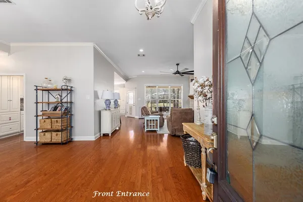 a view of a living room and kitchen with furniture wooden floor and a living room