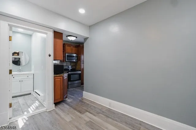 a kitchen with granite countertop a refrigerator and a stove