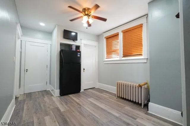 a view of a livingroom with a hardwood floor and a ceiling fan