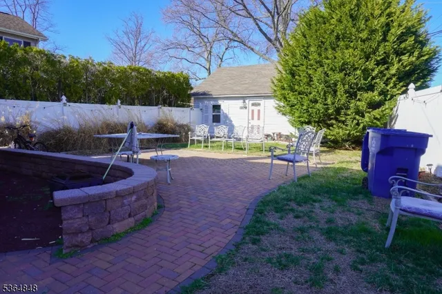 a view of a backyard with furniture and a fire pit