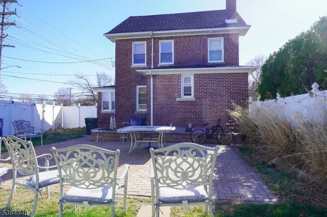 a view of a patio with table and chairs and potted plants
