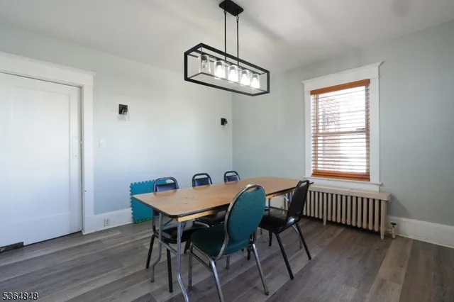 a view of a dining room with furniture wooden floor and a chandelier