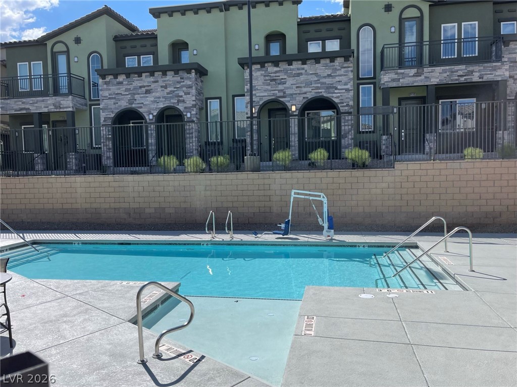6444 Spring Jog Street Las Vegas, NV 89166 - Photo 7 of 13 This inviting outdoor pool area features direct access to residential units, perfect for leisure.