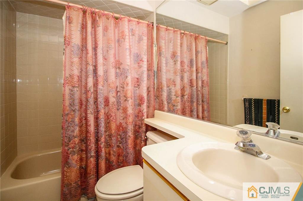 4005 Springbrook Drive Edison, NJ 08820 - Photo 22 of 25 a bathroom with a sink toilet and shower