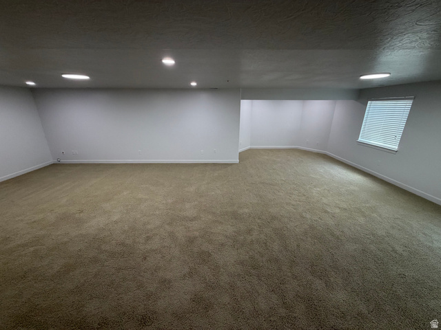 240 Bugle Way Providence, UT 84332 - Photo 28 of 33 Expansive room featuring neutral-toned carpeting, white walls, and recessed lighting