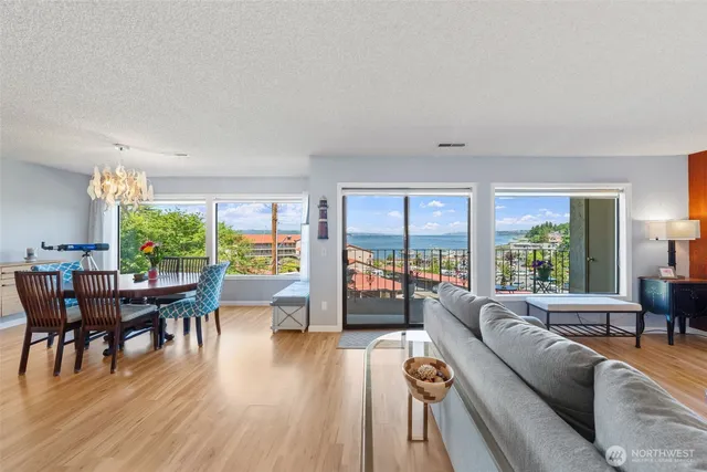 a living room with furniture dining table and a large window