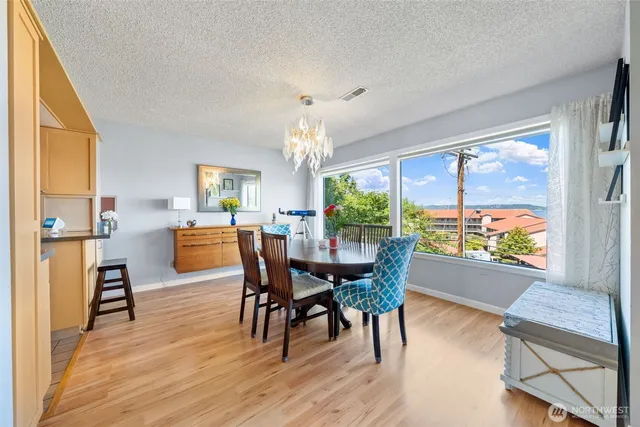a dining room with furniture window and wooden floor