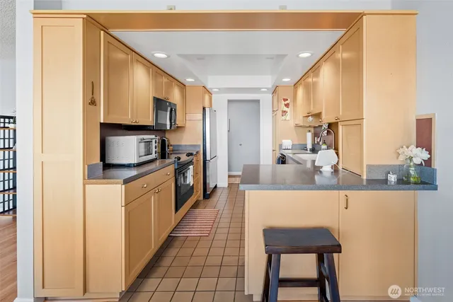 a large white kitchen with a large window