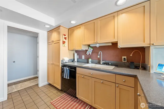 a kitchen with stainless steel appliances granite countertop a sink a stove and a refrigerator