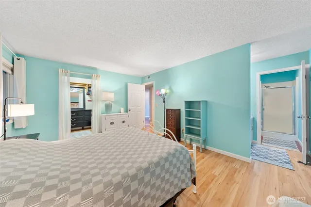 a bed room with a bed and a flat tv screen