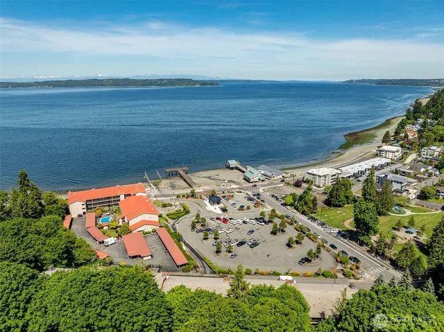 an aerial view of a house with a yard and lake view