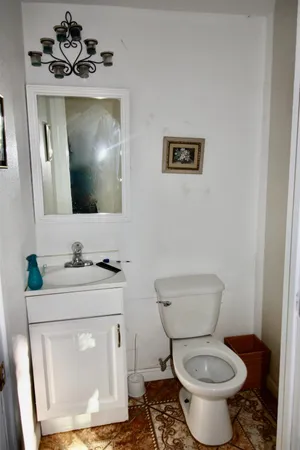 a bathroom with a toilet sink and mirror