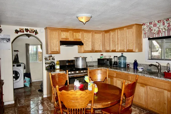 a kitchen with a stove a sink and a refrigerator