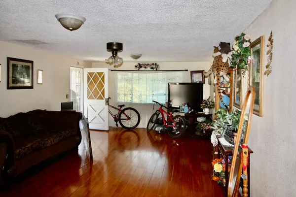 a view of a livingroom with furniture hardwood floor and a chandelier