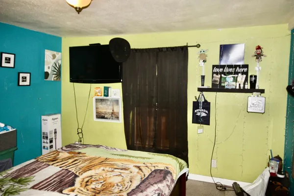 a bedroom with a bed and a television