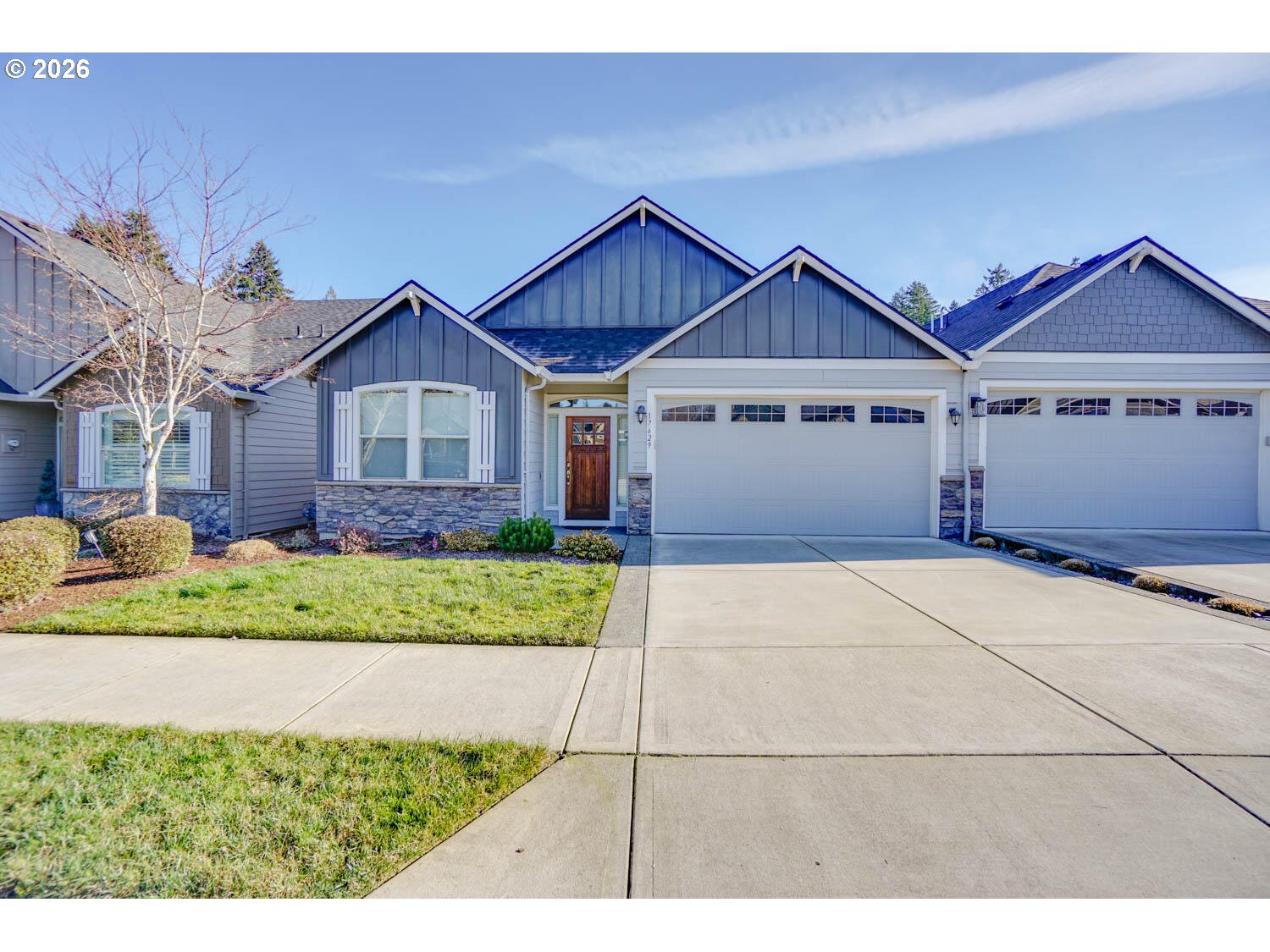 a view of a big house with a big yard and potted plants