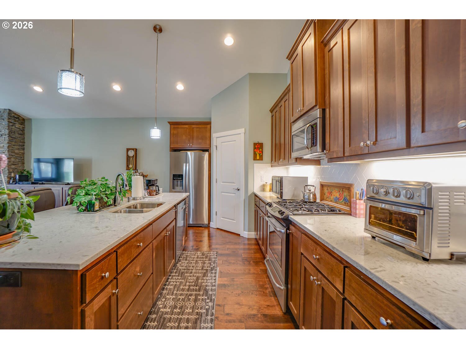 17629 Northeast 17th Avenue Ridgefield, WA 98642 - Photo 12 of 31 a kitchen with stainless steel appliances granite countertop refrigerator a stove top oven a sink dishwasher and wooden cabinets