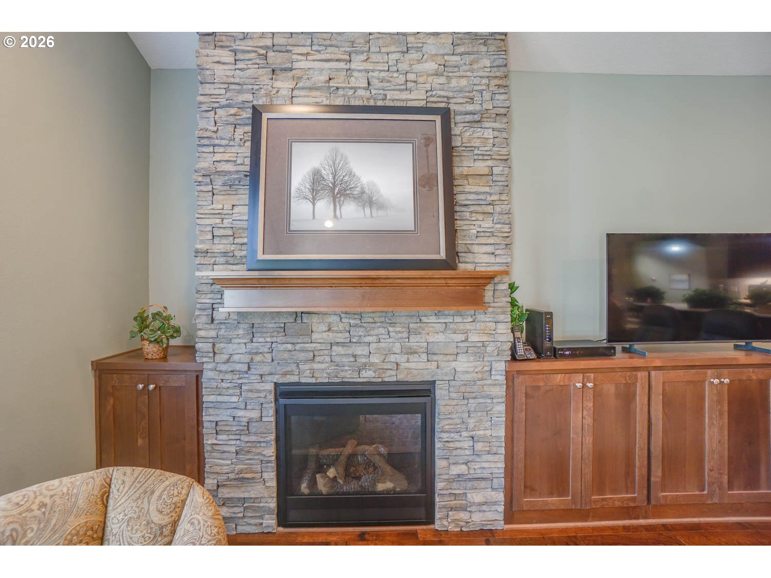 17629 Northeast 17th Avenue Ridgefield, WA 98642 - Photo 19 of 31 a living room with a fireplace and a flat screen tv
