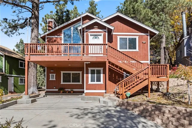 a view of a house with a yard and wooden fence
