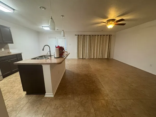 a kitchen with stainless steel appliances a sink and a refrigerator