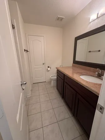 an empty room with kitchen view and a window