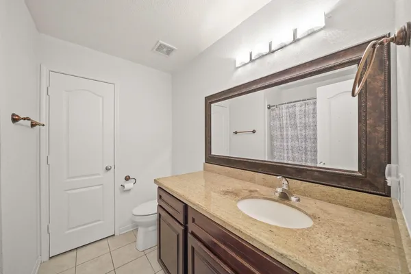 a kitchen with stainless steel appliances a stove top oven a sink a refrigerator and cabinets