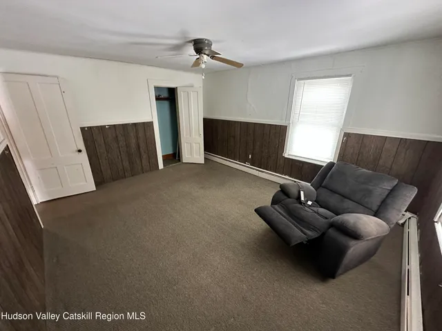 a view of a livingroom with an empty space and a hallway