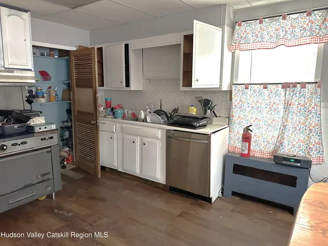 a kitchen with a sink cabinets and window