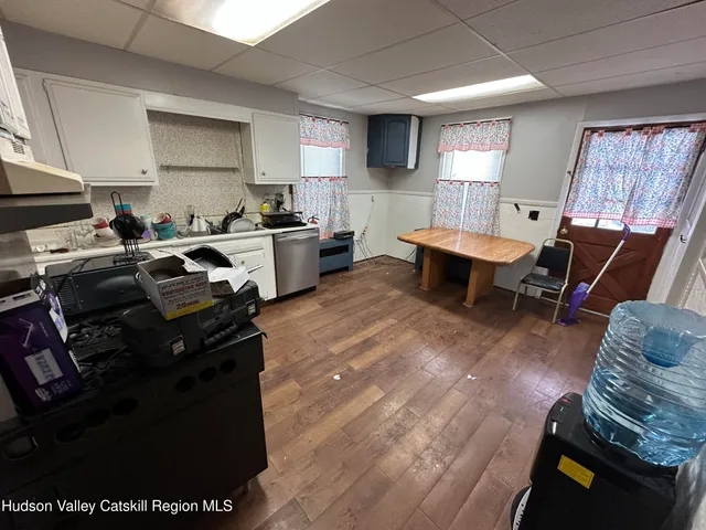 a living room with furniture a flat screen tv and a window