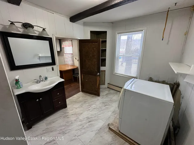 a bedroom with a bed and a mirror