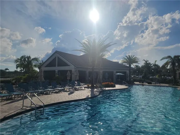 a view of a house with yard and sitting area
