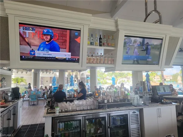a room with lots of frames and chairs