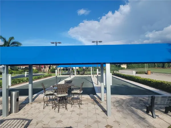a view of a swimming pool with outdoor seating