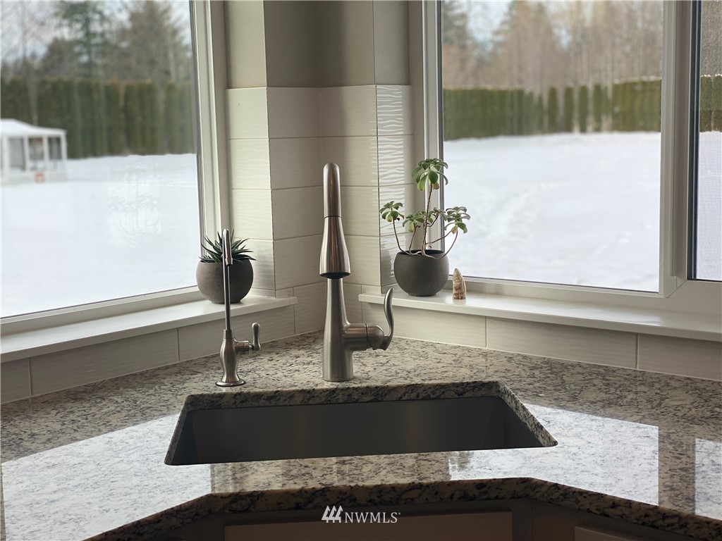 3519 McGee Road Blaine, WA 98230 - Photo 14 of 40 a bathroom with a granite countertop sink and a mirror