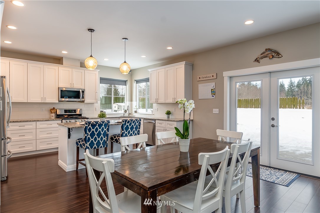 3519 McGee Road Blaine, WA 98230 - Photo 15 of 40 a view of a dining room with furniture window and wooden floor