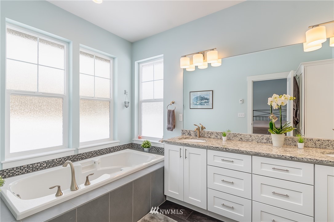 3519 McGee Road Blaine, WA 98230 - Photo 21 of 40 a bathroom with a granite countertop tub sink and mirror